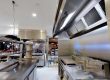 Stainless steel canopy above a wall-side cooking line at ENA Greek Street Food