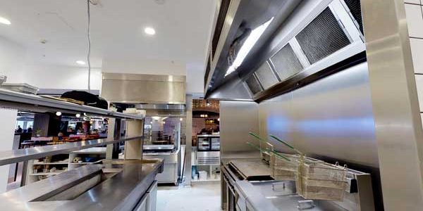 Stainless steel canopy above a wall-side cooking line at ENA Greek Street Food